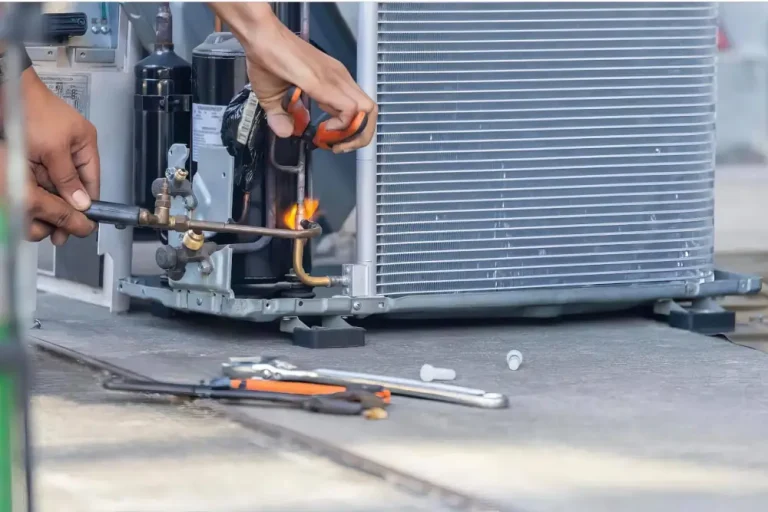 Air Conditioner Repair in London Ontario - Picture of an HVAC technician working on an AC unit.
