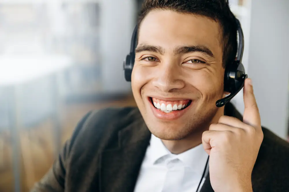 Looking For Excellent Heating Services in London, ON - Call center male representative smiling at the camera