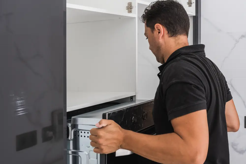 Man removing an oven