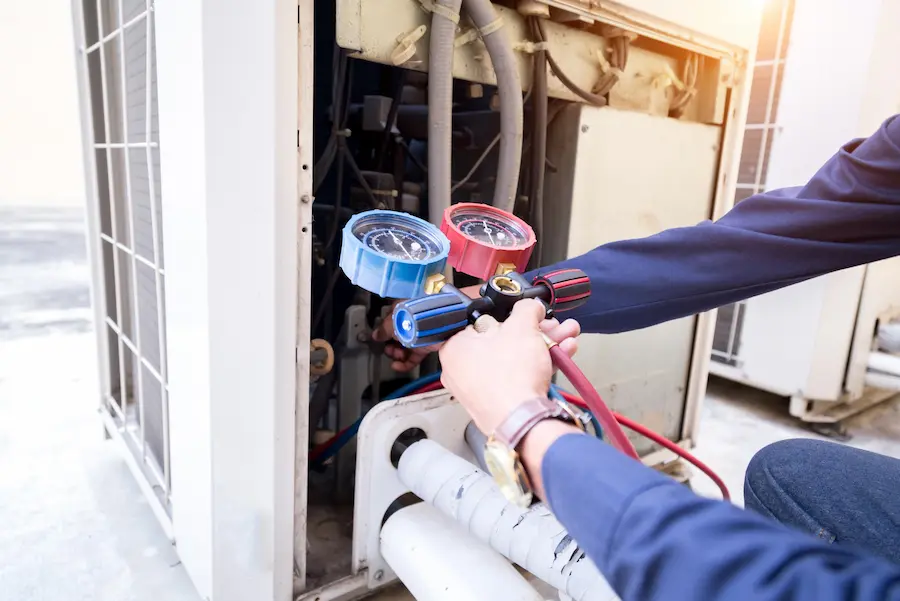 Technician repairing an AC unit